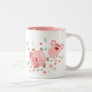 Deux mignons cochons de caricature dans la tasse d