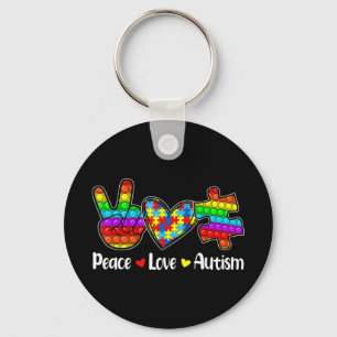 Deze nieuwsuitgave met Gezegden "Peace Love Autis" Sleutelhanger