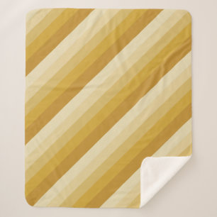Diagonale ombre strepen in goudtinten sherpa deken