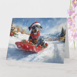 Dobermann-hond in slee Laat het sneeuwen Kerstmis Kaart