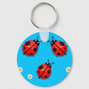 Drie kleurrijke lieveheersbeestjes op blauwe achte sleutelhanger