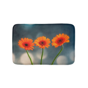 Drie Oranje Gerberas in een Row Bath mat