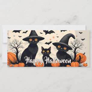 Drie zwarte katten met hoeden op Halloween