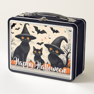 Drie zwarte katten met hoeden op Halloween