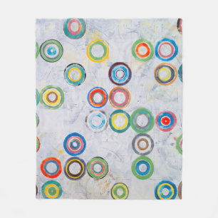 een abstract schilderij; meerkleurige cirkels op e fleece deken