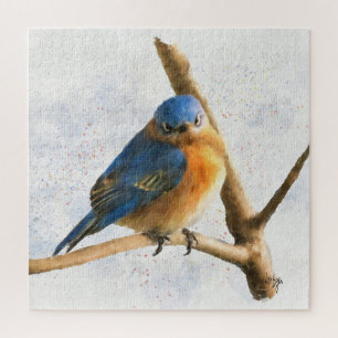 Een kikkerende blauwvogel rust op een vertakking legpuzzel