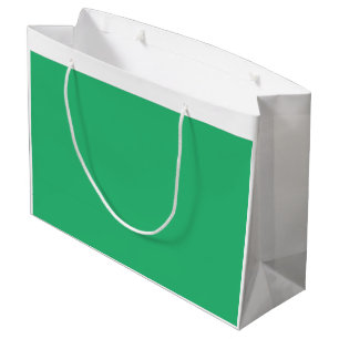 Een levendig groen blad met prominente aderen en e groot cadeauzakje