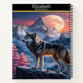 Een majestueuze wolf huilt bij het gloeiende maanl notitieboek (Achterkant)