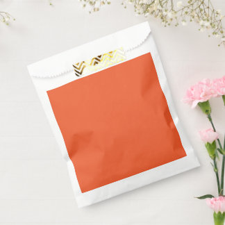 Een oranje achtergrond met een bedankzakje