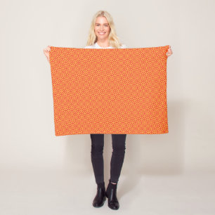 Een oranje en gele achtergrond met kleine vierkant fleece deken