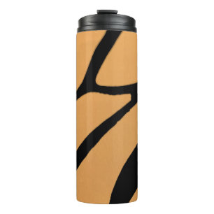Een oranje oppervlak met onregelmatige zwarte lijn thermosbeker
