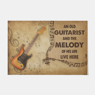 Een oude gitarist en de melodie van zijn leven deurmat