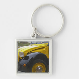Een oude zwarte en gele Citroen 2CV 2 CV, Sleutelhanger
