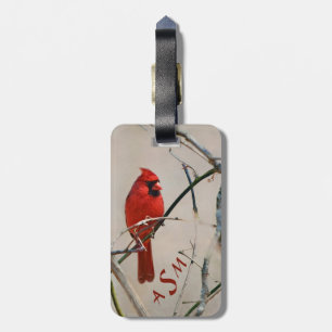 Een rode kardinaalvogel op een tak in het bos bagagelabel