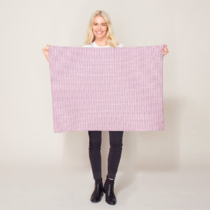 Een roze en witte achtergrond met golvende lijnen fleece deken