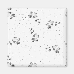 Een zwart-wit foto van een stel stippen magneet