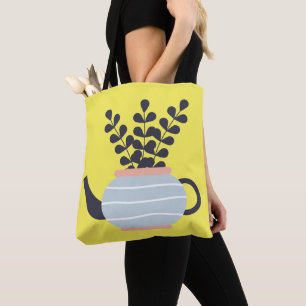Eenvoudige moderne theepot met plant pastel draagtas