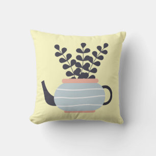 Eenvoudige moderne theepot met plant pastel kussen