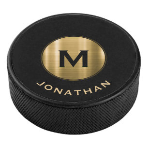 Eenvoudige zwarte goudcentrale monogram hockey puck