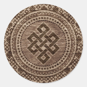 Eindeloze knoop decoratief op houten oppervlak ronde sticker