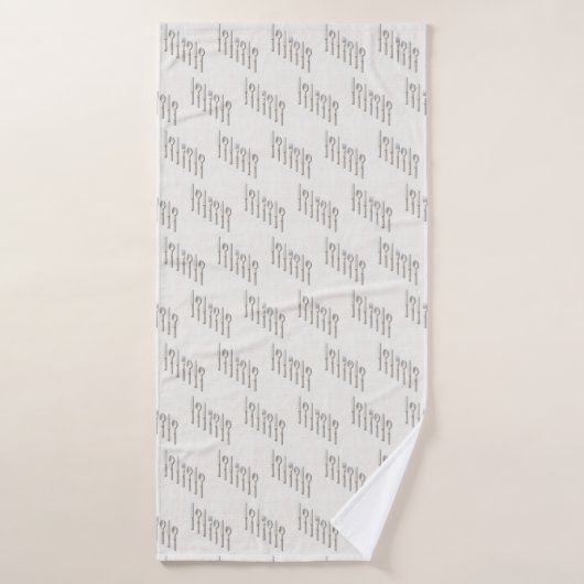 Elegant white and gold cutlery arranged diagonally (Serviette de bain)