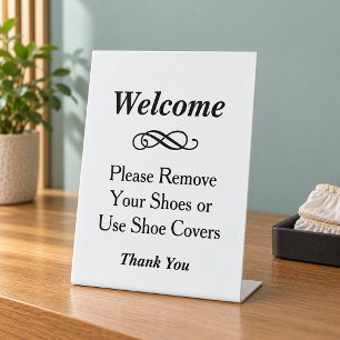 Elegante witte welkom verwijder schoenen reclamebord met voetstuk