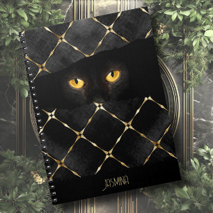 Elegante zwarte kat ogen in het donker notitieboek