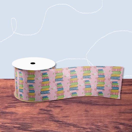 En Satin Ruban rose avec Pile de livres et de petites fleur