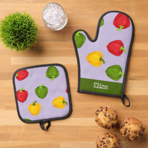 Ensemble De Gant De Cuisine Et De Manique Poivrons colorés sur violet