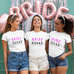 Équipe de mariées | Bridesmaid Chaud Rose Bachelor<br><div class="desc">"Bride Squad", un joli t-shirt féminin d'art, simple et élégant, avec une typographie moderne et minimaliste en noir et rose néon chaud dans un style cool et tendance. Le slogan, le nom et le rôle peuvent facilement être personnalisés avec les noms de votre fête de mariée, par exemple, mariée, demoiselles...</div>