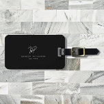 Étiquette À Bagage Monogramme minimaliste de luxe noir ivoire chic él<br><div class="desc">Chic et élégant,  cette étiquette de bagage monogramme moderne en blanc et noir est un design minimaliste sophistiqué qui combine votre monogramme dans un script écrit à la main le long d'élégante typographie serif. Sur le dos,  il y a de l'espace pour votre adresse.</div>