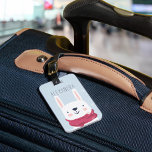 Étiquette À Bagage Tag de sac personnalisé de lapin d'hiver | Ciel<br><div class="desc">Cette adorable étiquette de bagage personnalisée fait un grand enfant en bas de fourre ou cadeau pour petits-enfants. Le design hivernal mignon est orné d'un arrière - plan bleu ciel enneigé avec une jolie illustration de lapin blanc décorée d'un casquette et d'une écharpe d'hiver roses. Personnalisez avec un nom ou...</div>