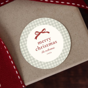 Étiquette de cadeau à carreaux avec noeud rouge de