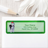 Étiquette Husky festif à Santa Hat sur Vert (En situation)