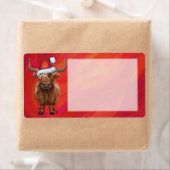 Étiquette Vache Highland à Santa Hat sur Red (En situation)