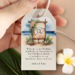 Étiquettes-cadeau Rustic Beach Destination Mariage Sac de bienvenue<br><div class="desc">Les étiquettes d'accueil de mariage de plage de destination pour vous de personnaliser vos sacs cadeaux de bienvenue. Ce charmant design présente une scène aquarelle d'un panneau d'accueil romantique et rustique, sur une plage en bord de mer, décorée de fleurs tropicales. Idéal pour un mariage décontracté ou boho plage, un...</div>