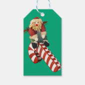 Étiquettes-cadeau Santa Claus plays on candy can slide for fun. (Devant)