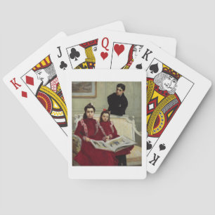 Familieportret van een jongen en zijn twee zusters speelkaarten