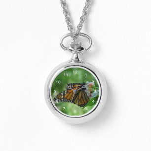 fladderende monarchvlinder op roze bloem horloge