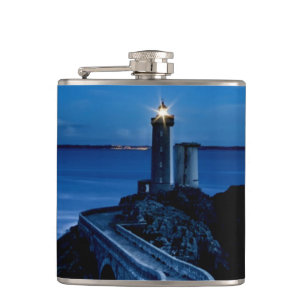 Flasques Phare sur mur dans l'océan la nuit