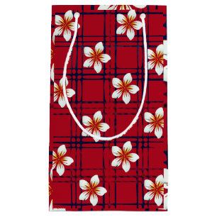 Fleur blanche sur sac cadeau rouge et bleu