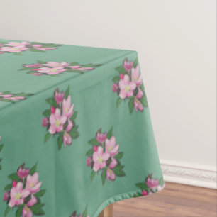 Fleurs de pommier pastel sur nappe verte