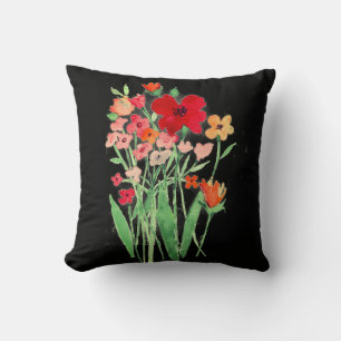 Fleurs sauvages roses et rouges sur un coussin jet