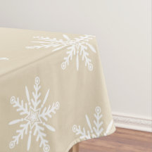 Flocons de neige blancs sur la nappe beige de Noël