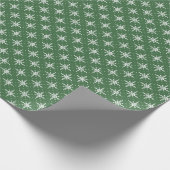 Flocons de neige blancs sur un papier cadeau vert (Coin)