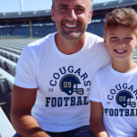 Football personnalisé Papa Marine Blue and Gold Te<br><div class="desc">T-shirt de football avant et arrière personnalisés pour papa - montré en Design blanc pour les papas de football présente un casque de football avec texte sportif qui peut être customisé pour le nom de l'équipe, le nom de famille du fils, et son numéro de maillot. Les couleurs or et...</div>