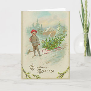 Garçon avec la carte de Noël de traîneau