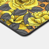 Gele rozen met grijze bladeren op sinaasappel bureaumat (Hoek)
