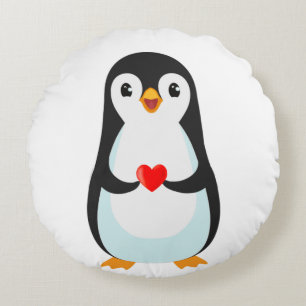 Gelukkige pinguïn met een hart rond kussen