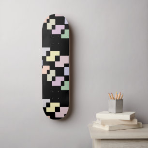 Geometrische verloopblokken op zwart skateboard